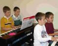 Piano class boys playing duets.