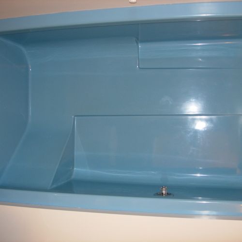 Blue fiberglass shower before refinish