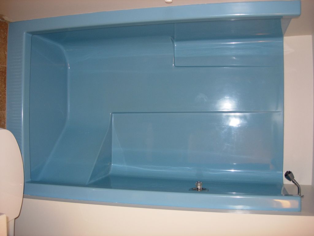 Blue fiberglass shower before refinish