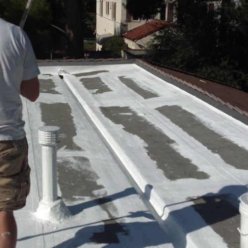 Acrylic Coating being Installed on a Flat Roof In 
