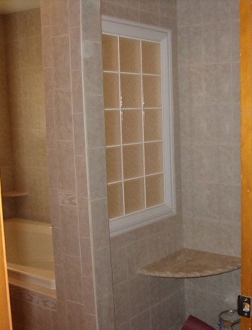 Custom tile shower with glass block to bring in so