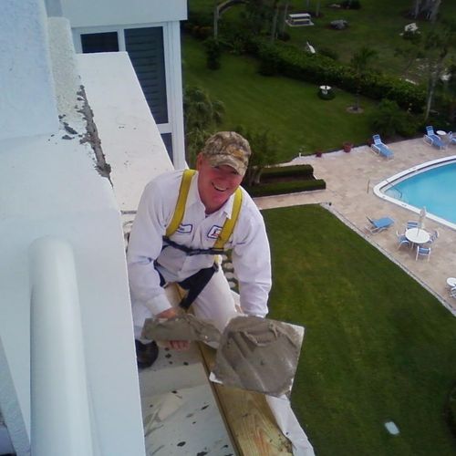 Bill Arnold, owner, hard at work on a condo ledge