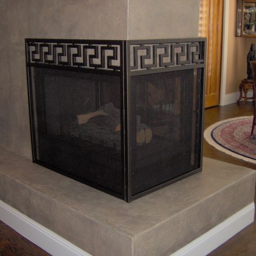 A three sided fireplace screen with Greek freeze v