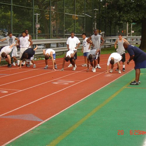 Athletes learning correct stance for sprint start.
