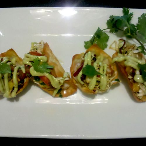 Lobster tacos in baked gyoza shell with all the go