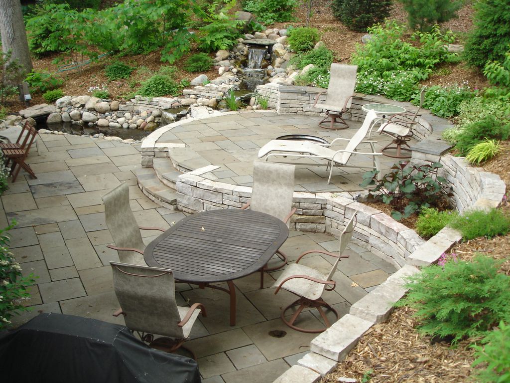 Custom stone walls, planters, firepit, and bluesto