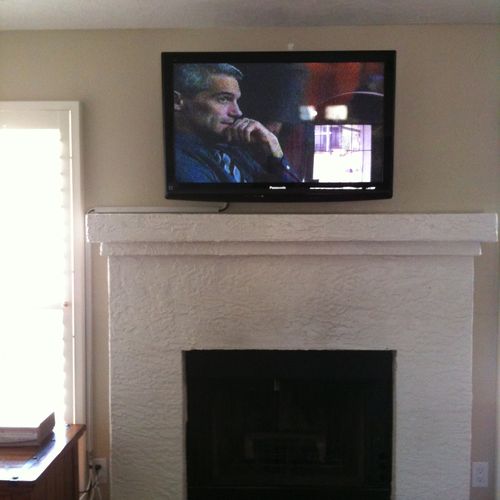 Flat screen TV wall mount above fireplace, with ca