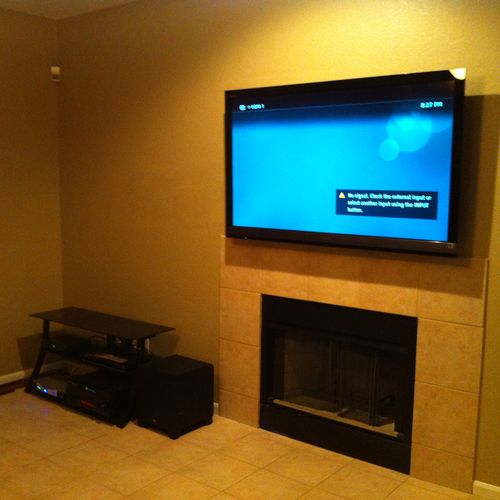Flat screen TV wall mount above fireplace, with ca