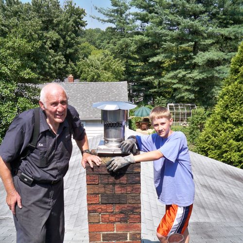 Ken and Jacob Barr on top of the roof with the fin