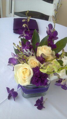 Purple, ivory and greens for a tropical centerpiec