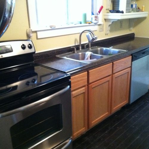 Installed appliances, set counters and cabinets.