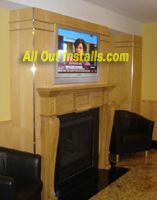 Flat Screen TV mounted over fireplace with all wir