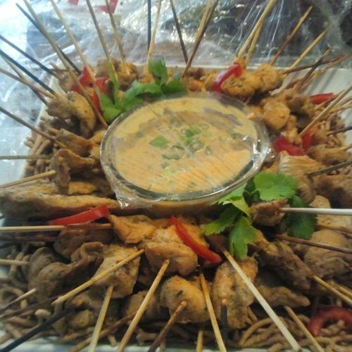 Traditional chicken satay skewers with spicy (or m