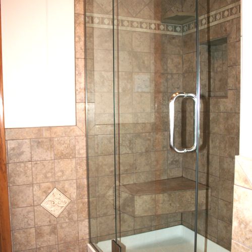 Custom frameless shower door, tiled built in seat,