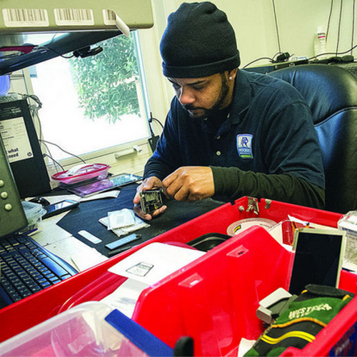 Technician working on a iPhone cell phone repair.