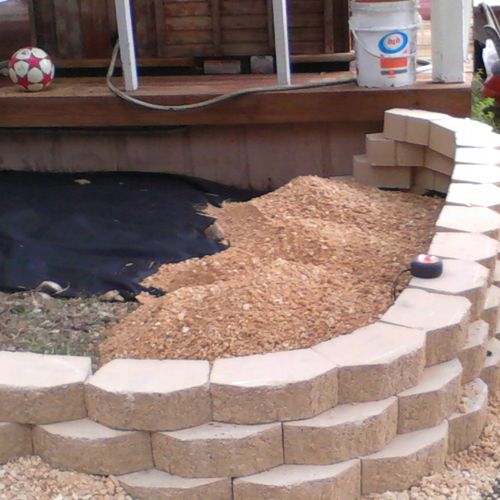 WITH RETAINING WALL AND WEED BARRIER AND GRAVEL