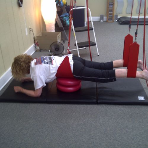 Client doing Redcord Supine plank with back suppor