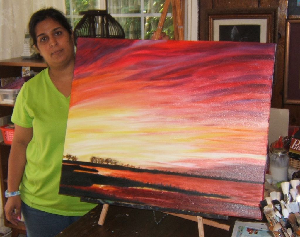 An adult student and her recent painting.
