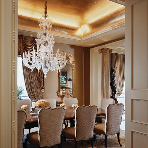 Elegant dining room with gold-leafed ceiling