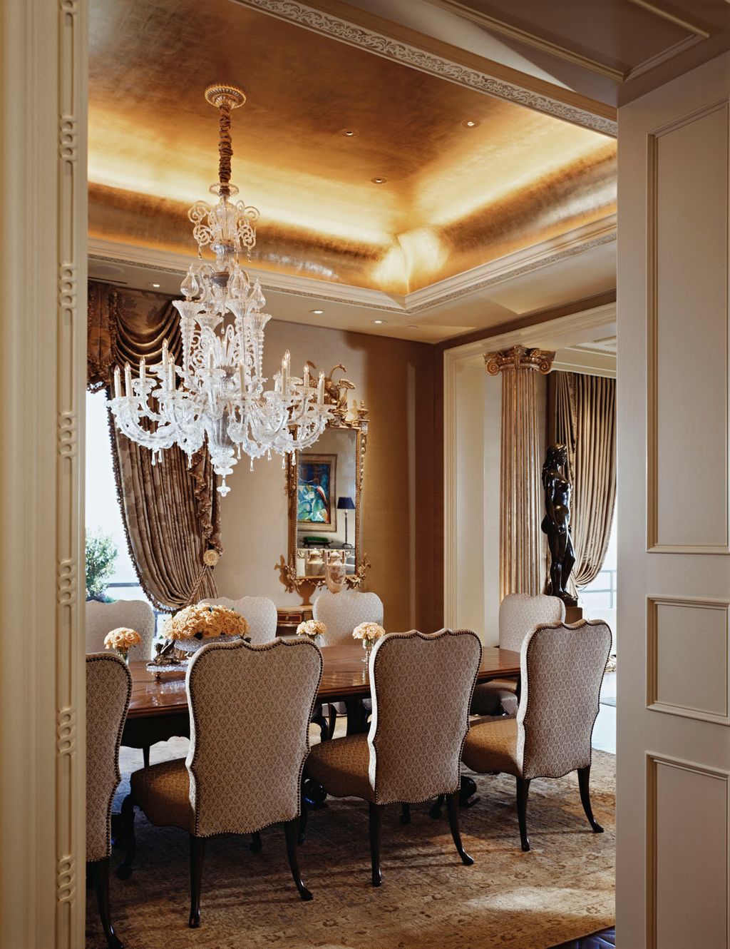 Elegant dining room with gold-leafed ceiling