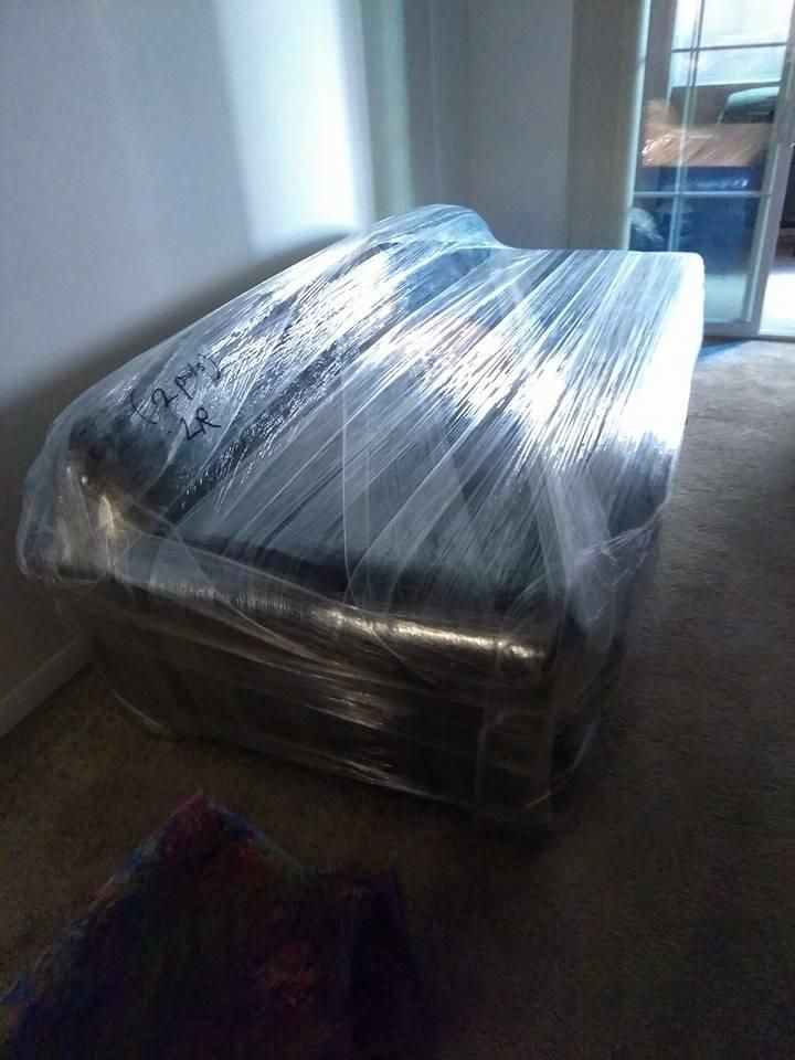 Couch wrapped with moving blankets