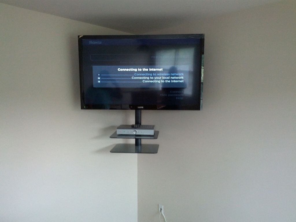 42 inch TV with a swivel corner mount up high for 
