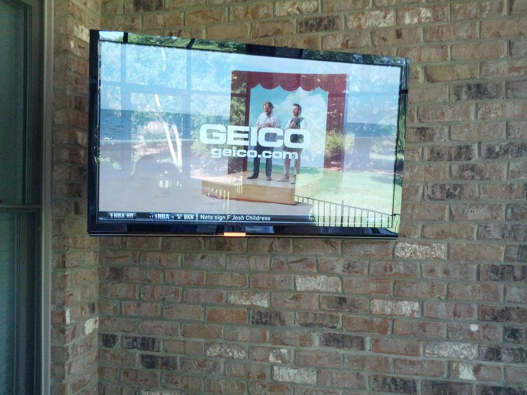 55 inch TV mounted in a covered screen porch.
