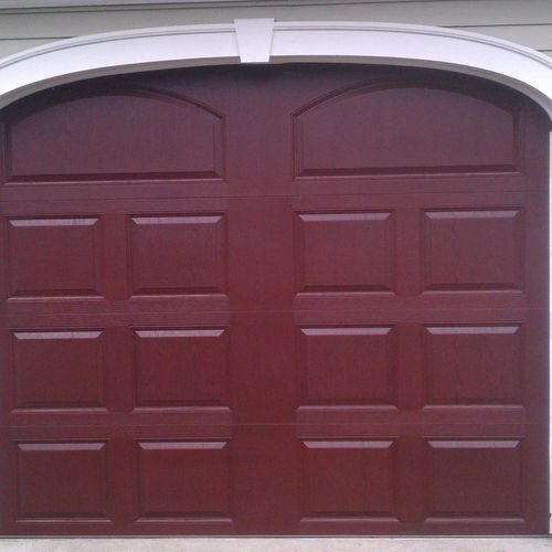 Insulated fiberglass door with stained wood look.
