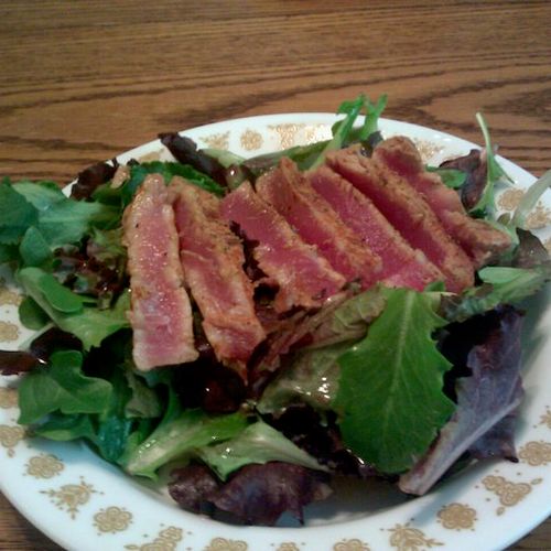 seared, wild ahi tuna on a bed of mixed greens wit