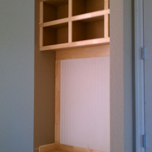 Custom shelves and storage placed on blank wall at