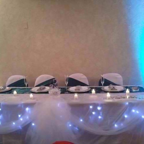 Bridal table with lights and side tied sashes.