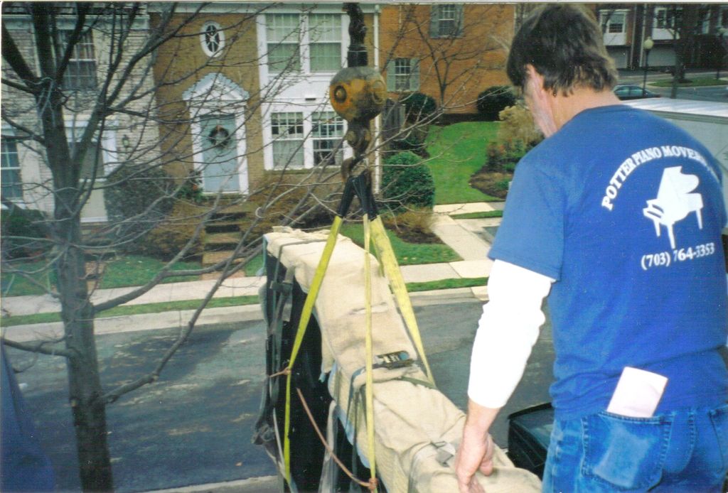 Moving a concert pianist's piano by crane.