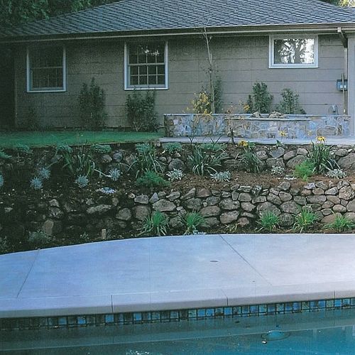 Beautiful natural stone wall adjacent to pool with