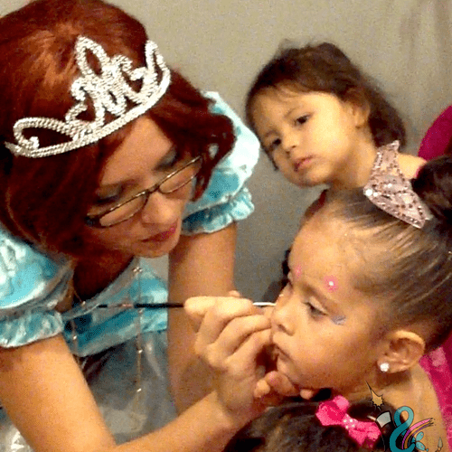 Princess Sparkles face painting the birthday girl.