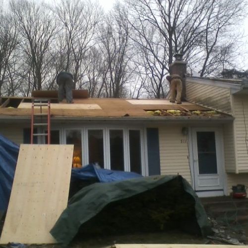 Replacing plywood on lower roof.