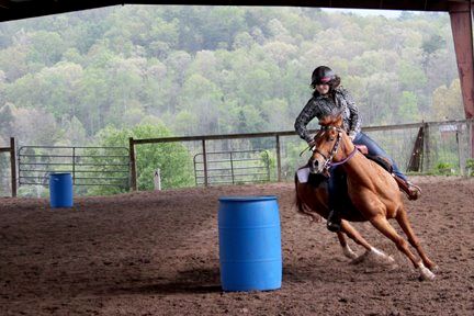 Running the Barrels at a Blue Point Stables Horse 