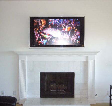 A very nice Sony TV over a great white fireplace