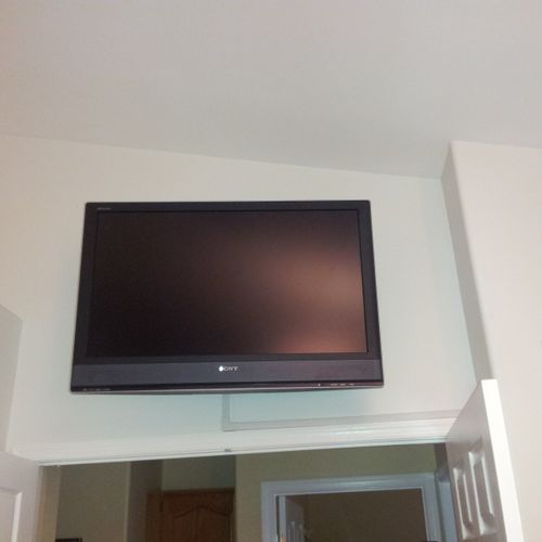 42" Sony LCD mounted on cantelever over doorway in