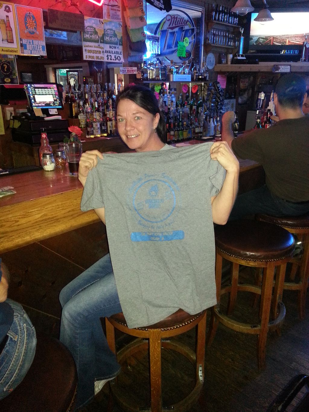 Lisa receiving a T-shirt  for her 10th visit to ou