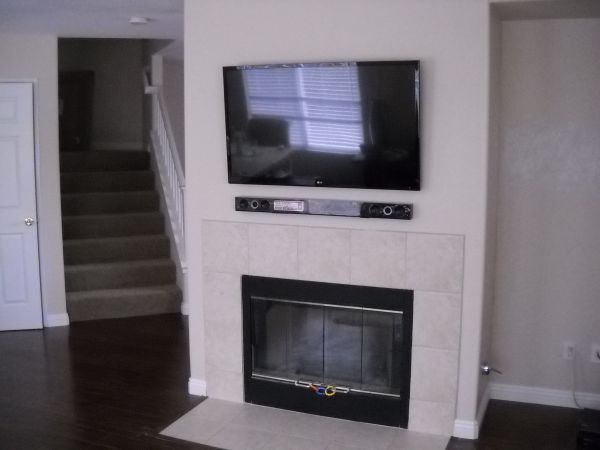 Flat Screen TV Mounted Over Fireplace with soundba