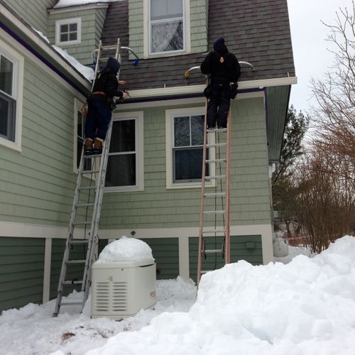 Installing new gutters out on Peaks Island, Maine