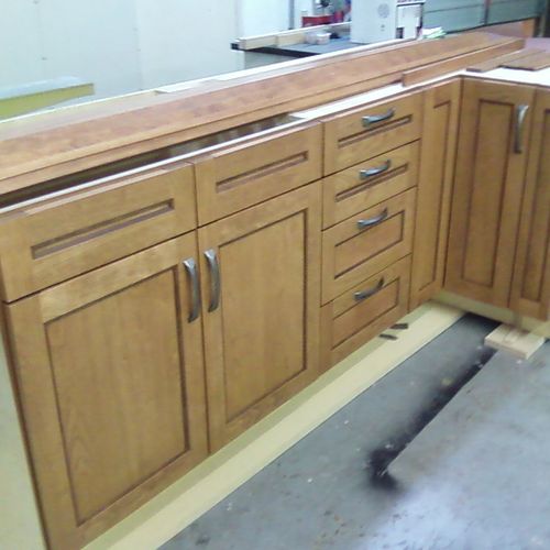 Cherry wood kitchen Cabinets with walnut trimming.