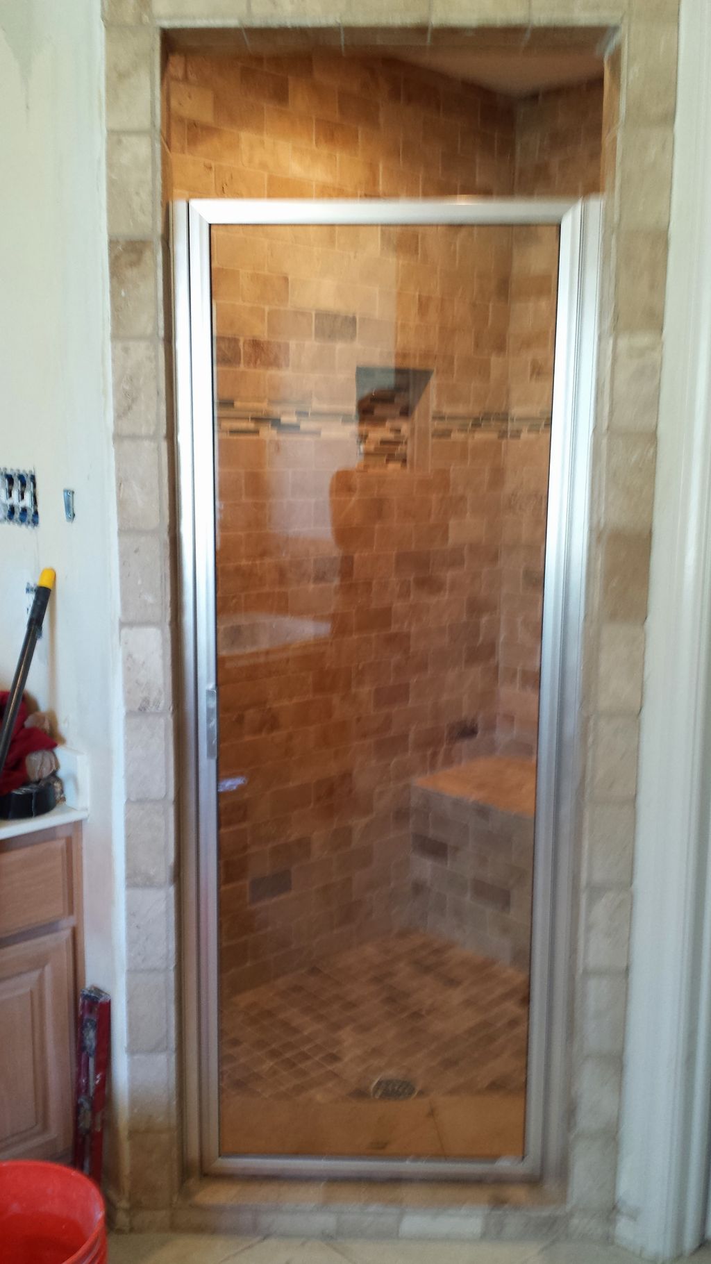 Completed shower with glass door.