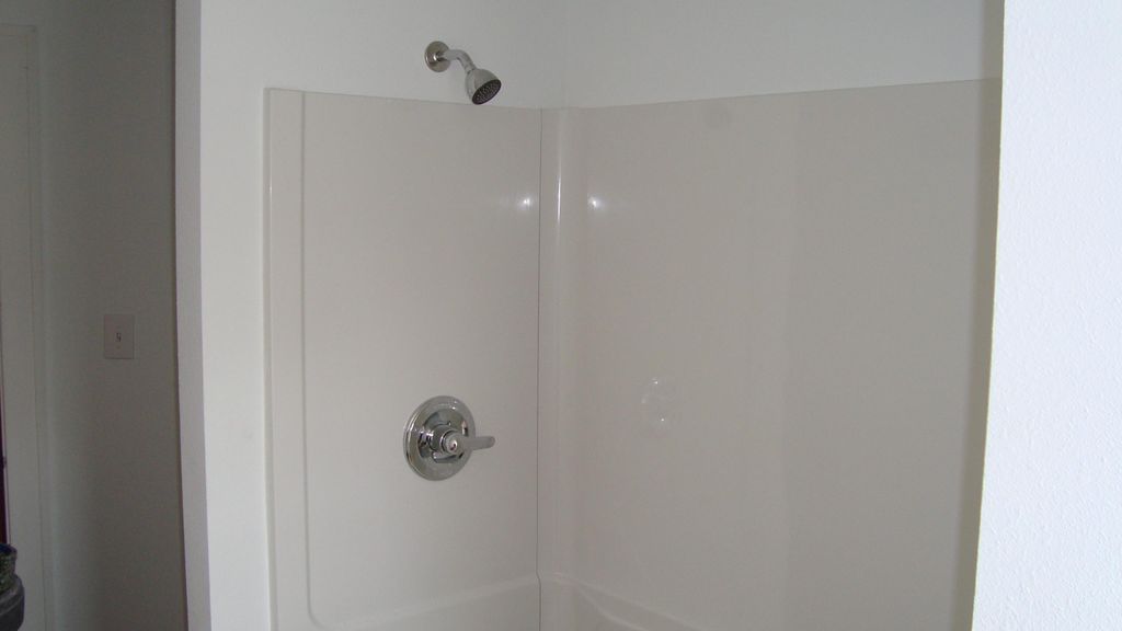 bathroom tub with shower surround install in a hou