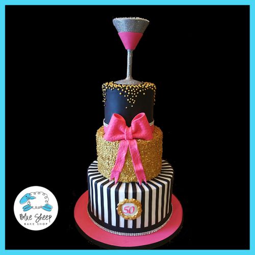 Three tiered fondant 50th birthday cake with a fas