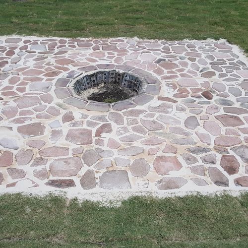 finished paver patio with fire pit in the middle 