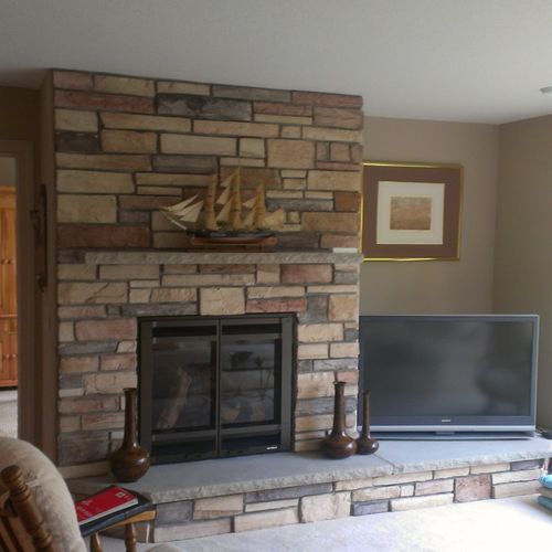 Basement remodel with stone fireplace.