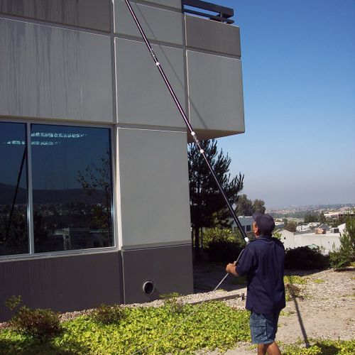 Cleaning windows at one of our many commercial cus
