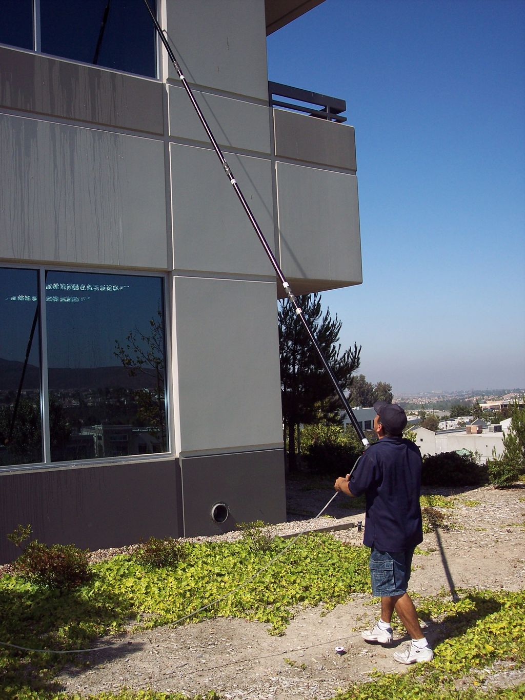 Cleaning windows at one of our many commercial cus