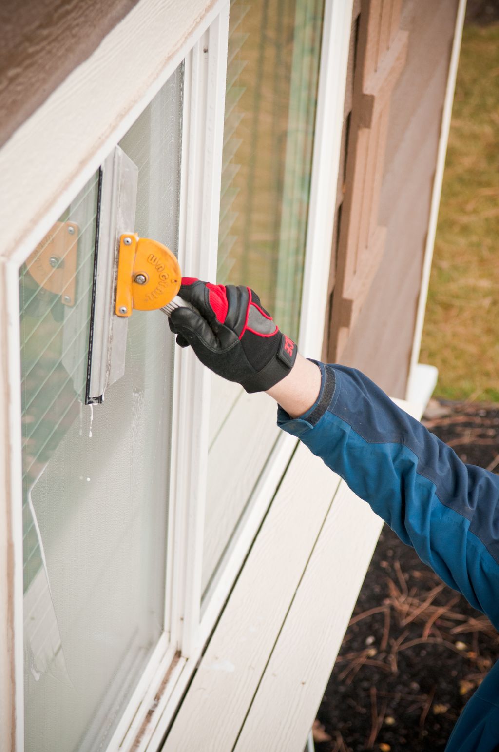 Using a squeegee we clear the window of dirt and d